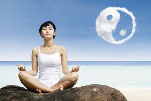 Beautiful girl meditate under yin yang cloud