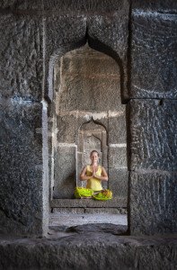 Woman doing meditation in the temple of Hampi Karnataka India ** Note: Visible grain at 100%, best at smaller sizes