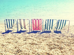 chill on beach with retro stripes sun bed / cross processing style
