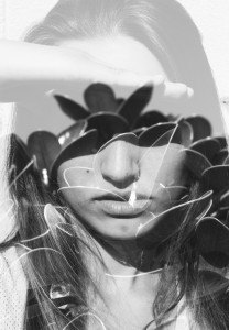 Double exposure portrait of young lady combined with photograph of nature