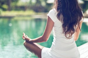 Close up Rear View of Slim Woman Meditating in a Lotus Yoga Posi